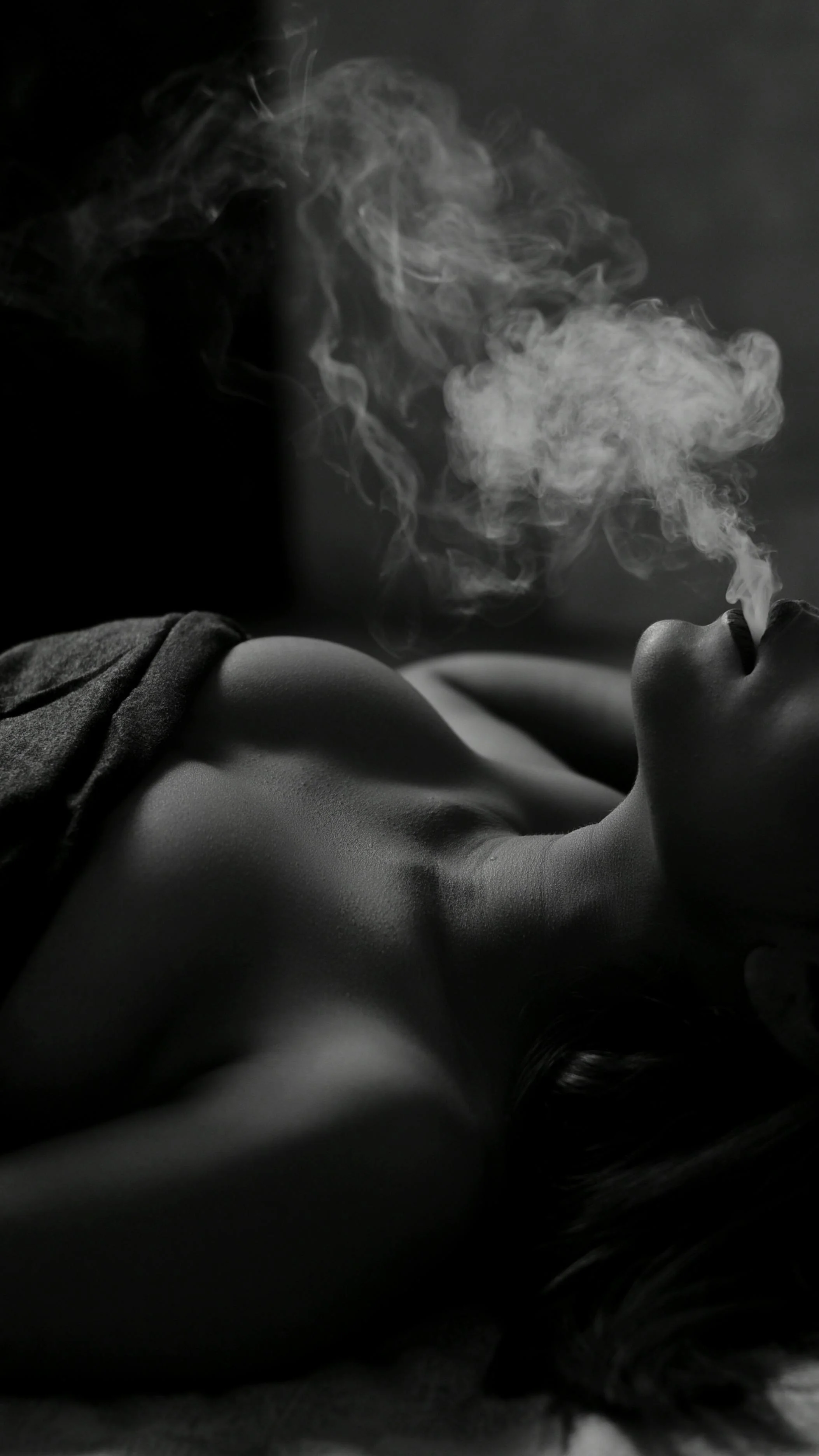 Black and white portrait, smoke drifting upward