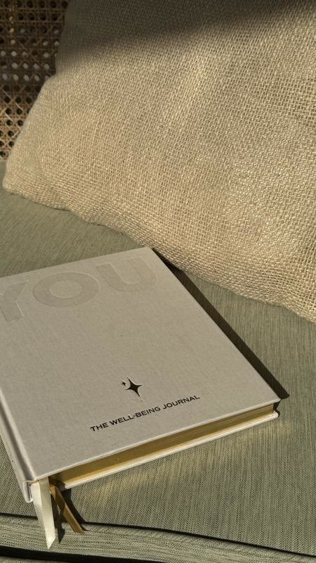 A linen notebook on a sunlit table